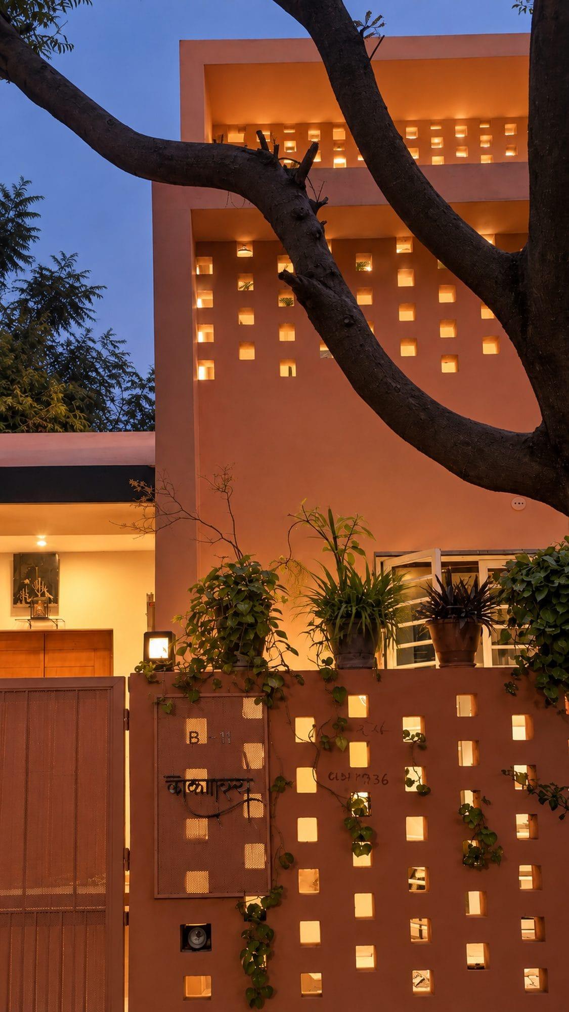The perforated façade glowing at dusk
