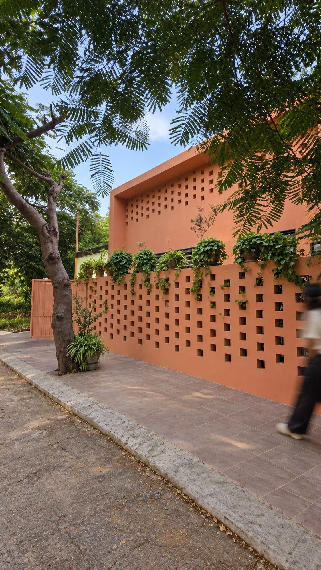 The long brick screen wall along the street